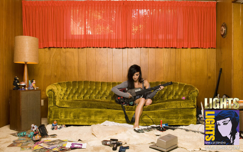 woman playing guitar on couch