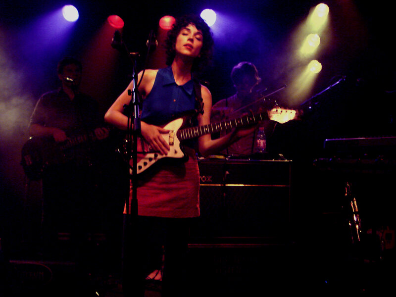 woman playing guitar on stage