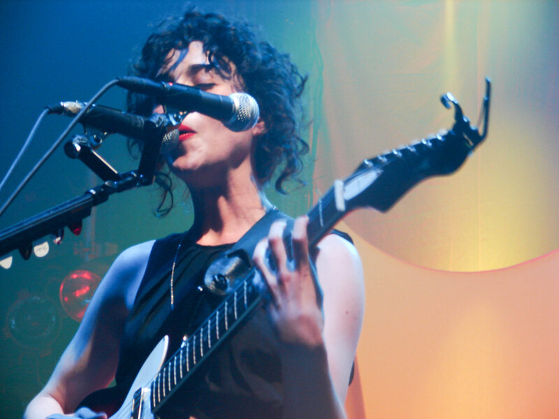 woman playing guitar on stage