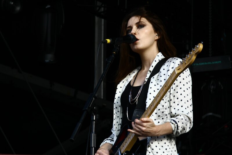 woman playing guitar on stage