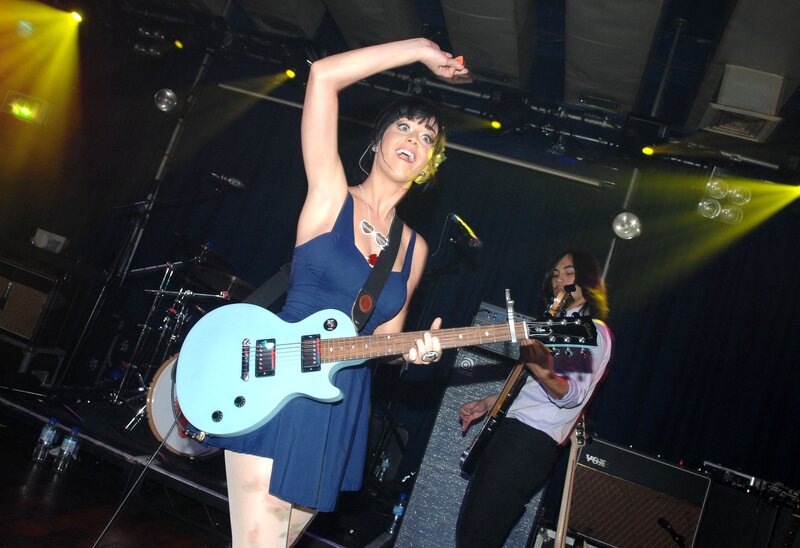 Woman playing guitar on stage