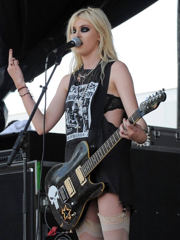 woman playing guitar on stage