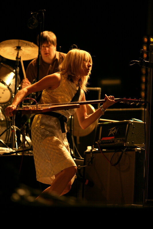 woman playing guitar on stage