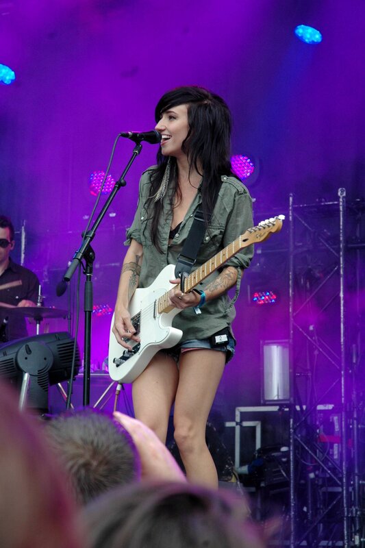 Woman playing guitar on stage