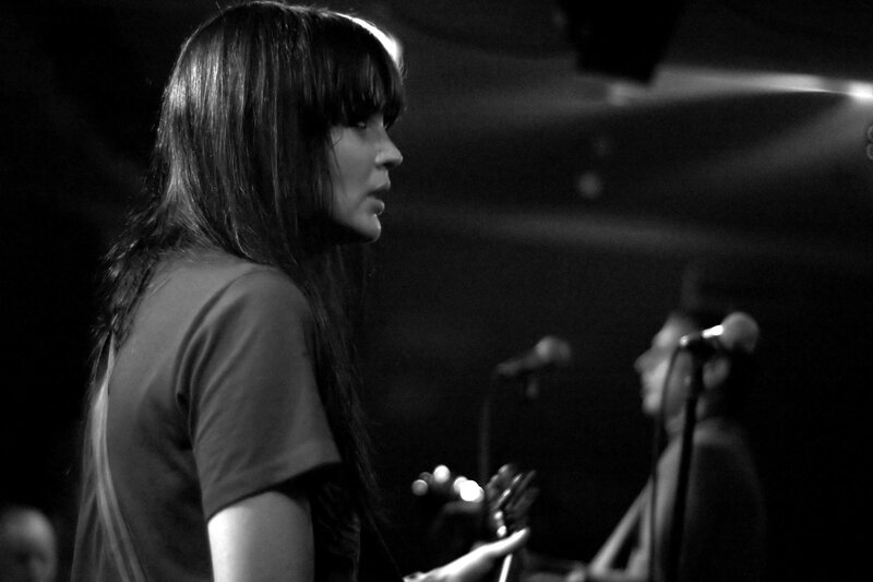 woman playing guitar on stage