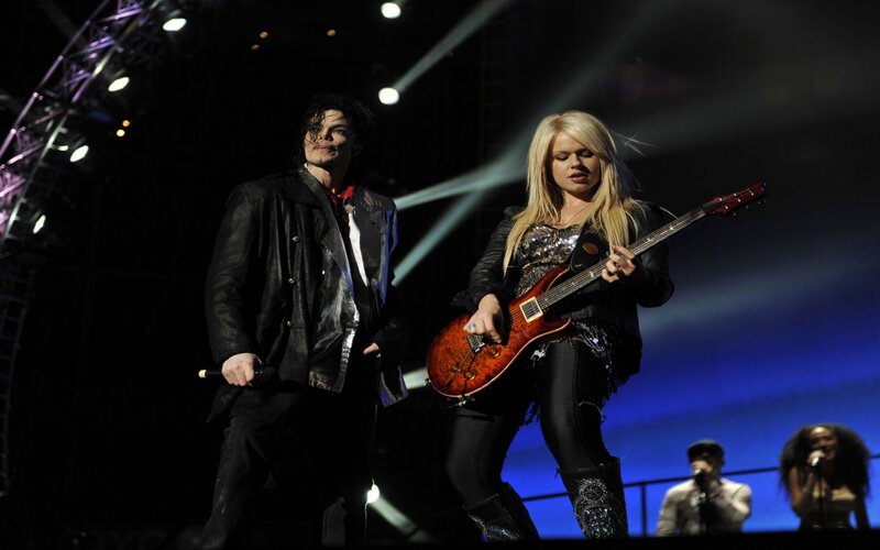 Woman Playing Guitar on Stage — Black, Dramatic