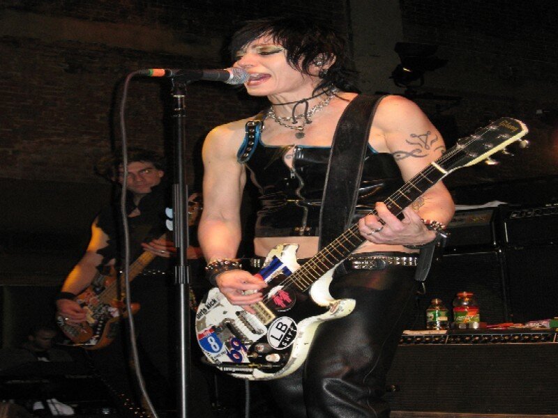 Woman Playing Guitar on Stage — Black