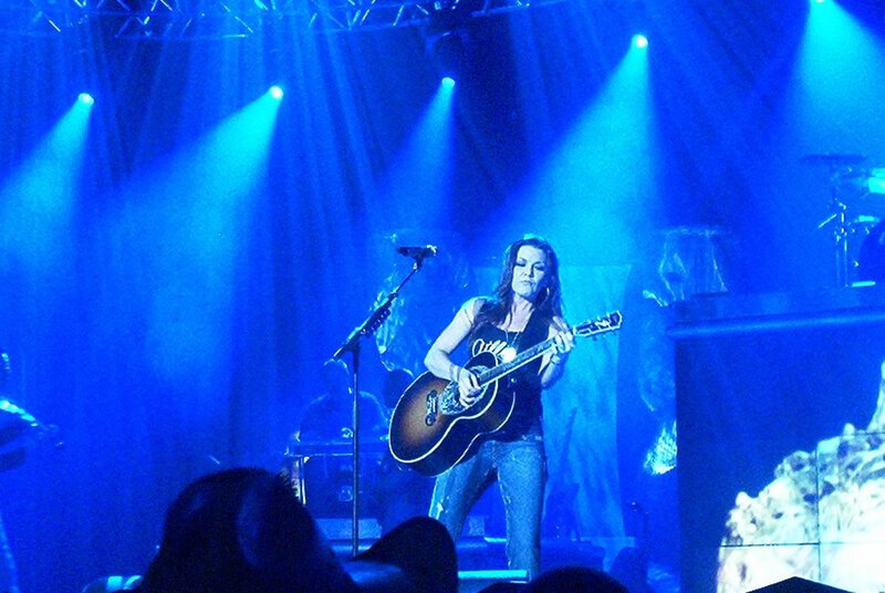 Woman Playing Guitar on Stage — Blue, Dramatic