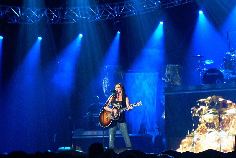 Woman Playing Guitar on Stage — Blue