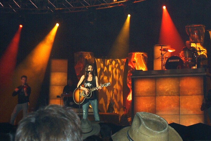 Woman Playing Guitar on Stage — Orange