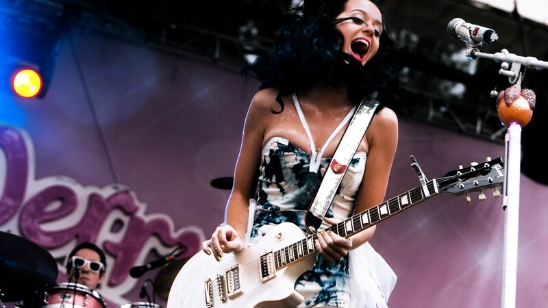 Woman Playing Guitar on Stage — Purple, Energetic, Photograph