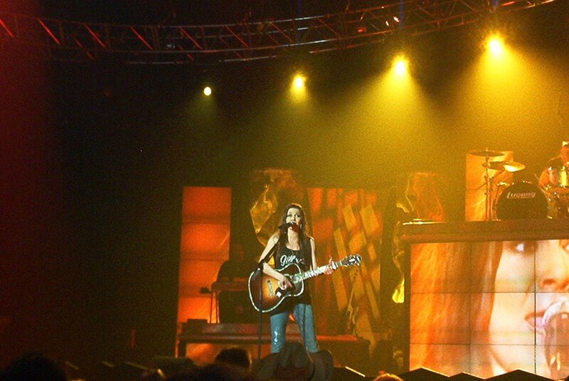 Woman Playing Guitar on Stage — Yellow