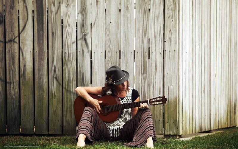 Woman playing guitar outdoors