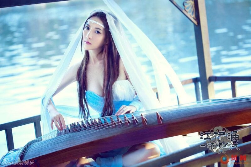 woman playing guzheng on boat