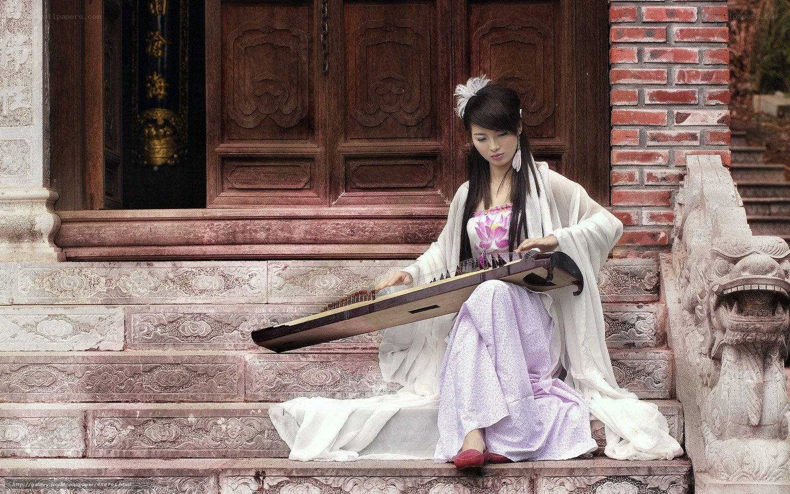 Woman playing guzheng on steps