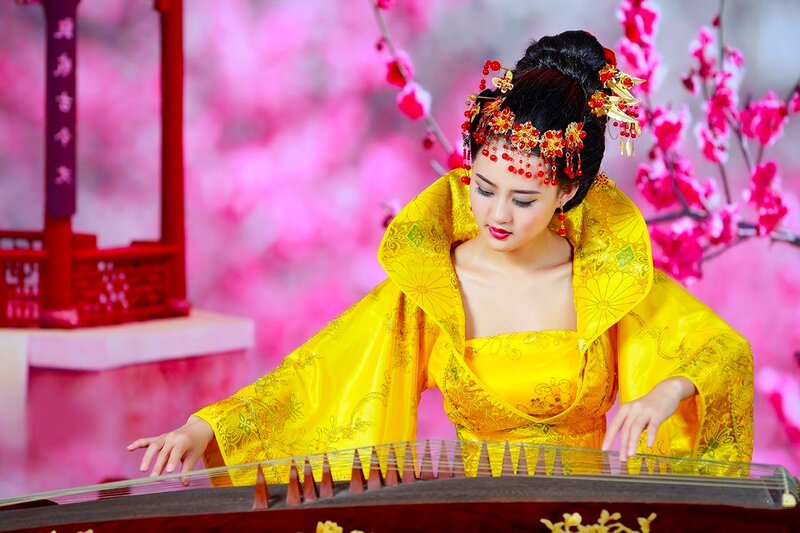 Woman Playing Guzheng — Yellow