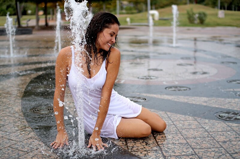 woman playing in fountain