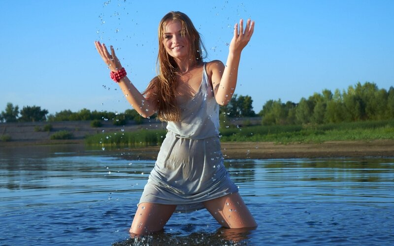 woman playing in river water