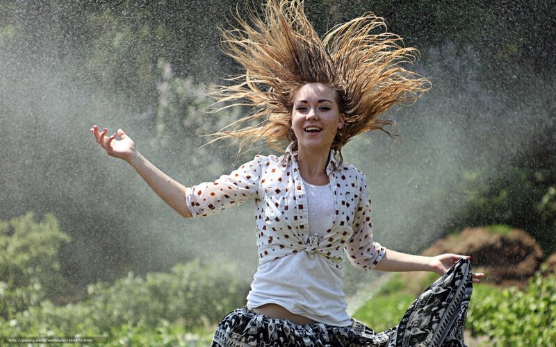 woman playing in water spray