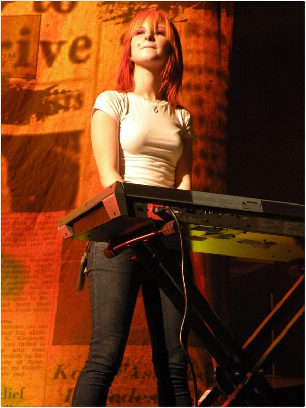 woman playing keyboard on stage
