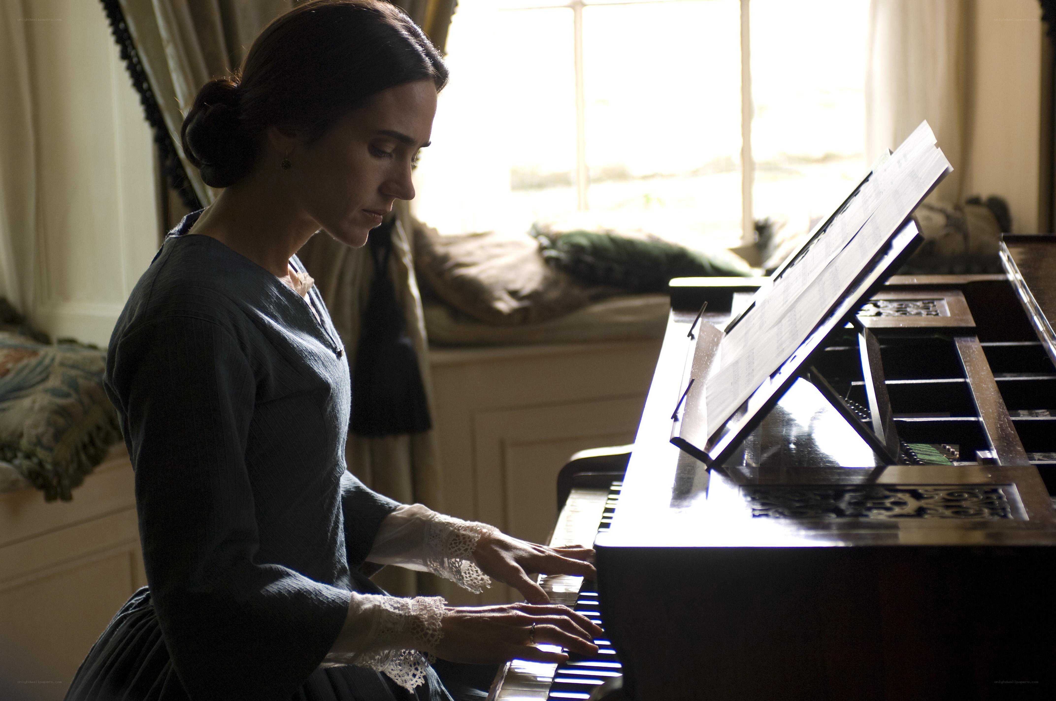 woman playing piano by window