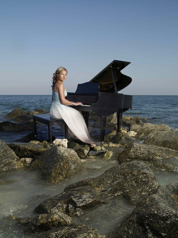 Woman playing piano on beach