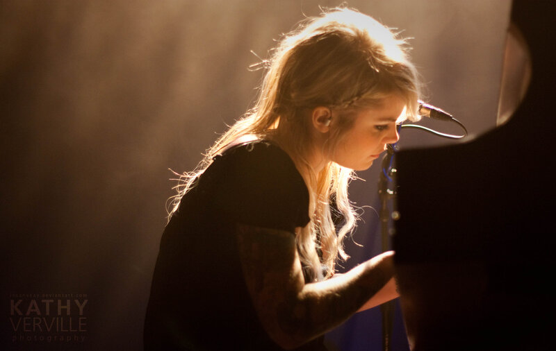 woman playing piano on stage