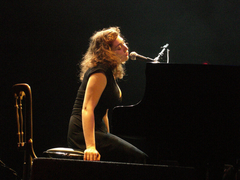 woman playing piano on stage