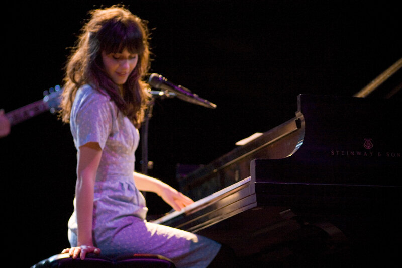 woman playing piano on stage
