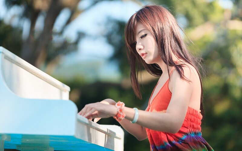 woman playing piano outdoors