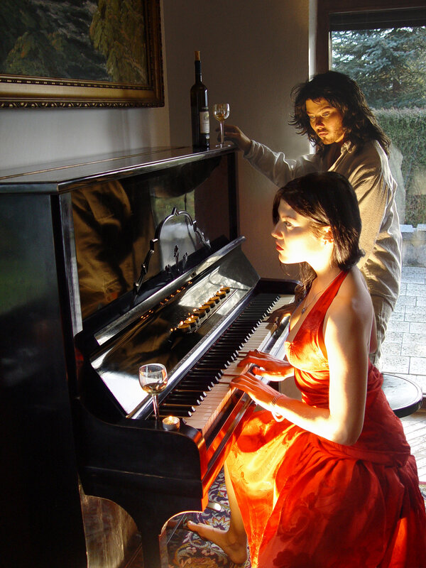 Woman playing piano with man