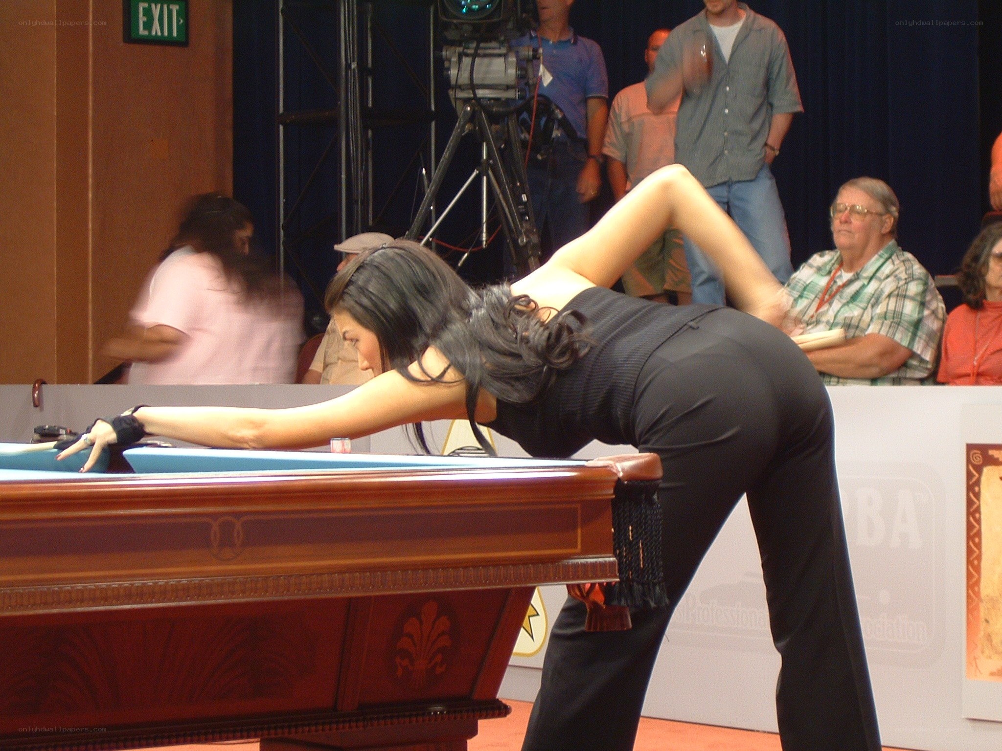 woman playing pool at event