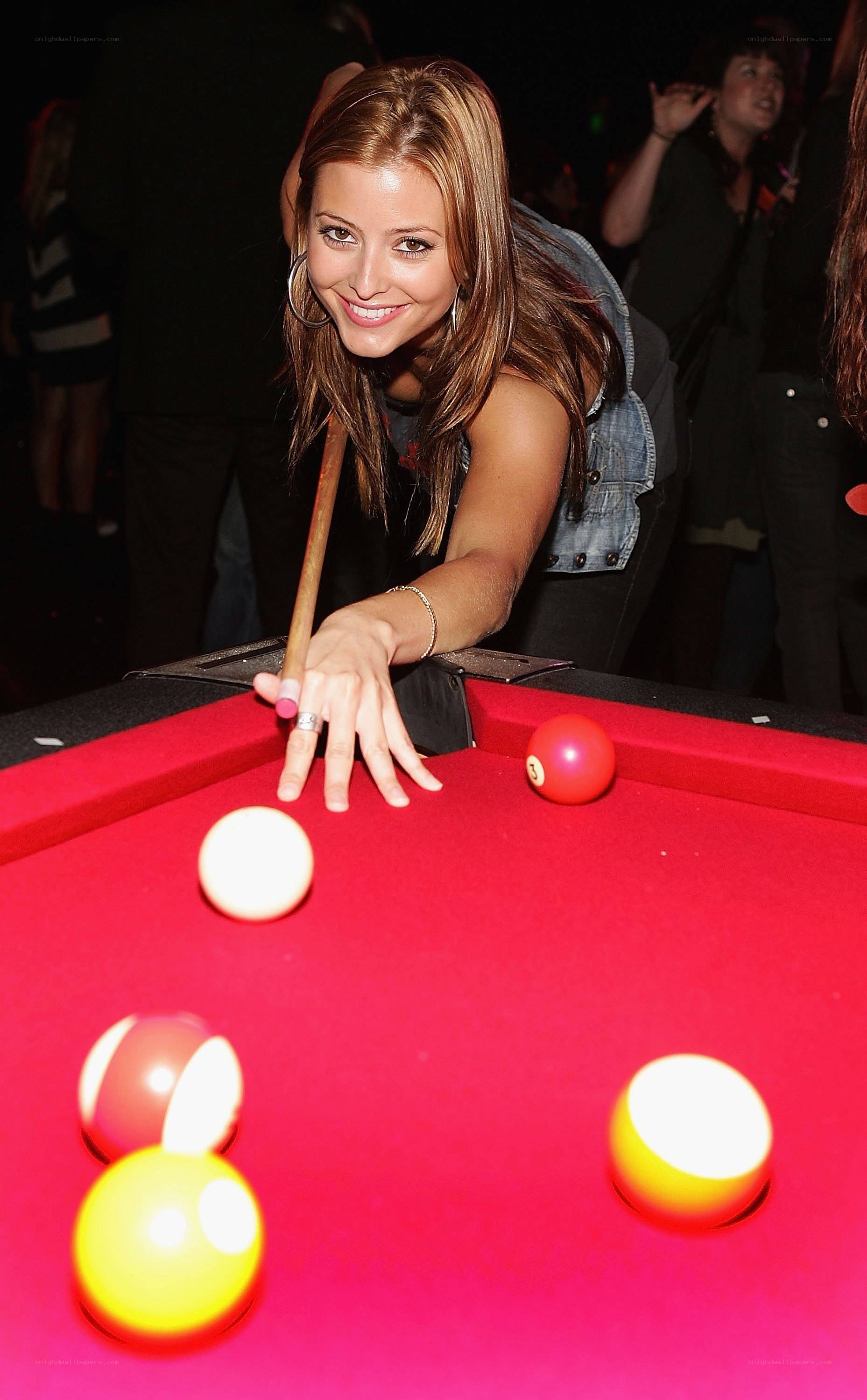 Woman playing pool at event