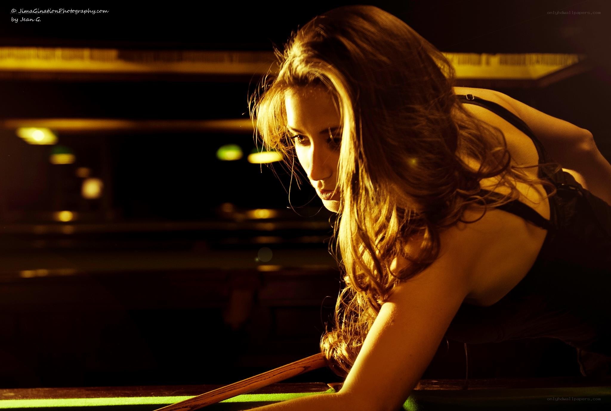 woman playing pool at night