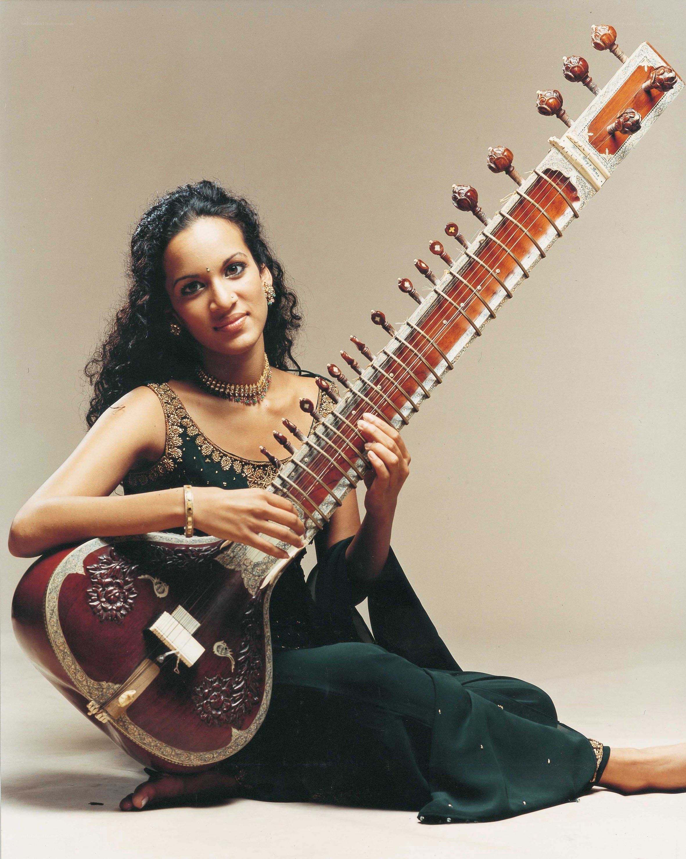 Woman playing sitar instrument