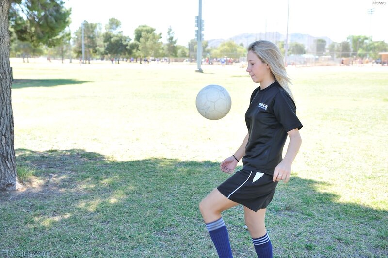 woman playing soccer outdoors