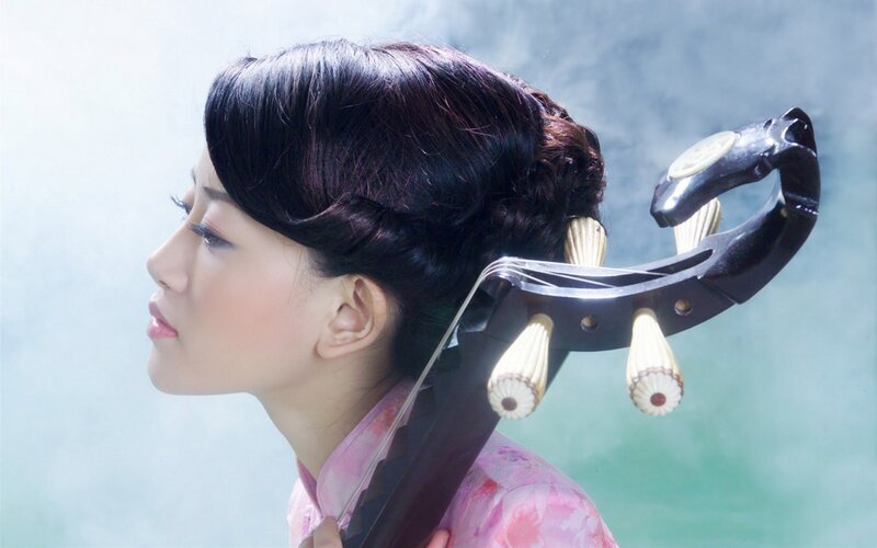woman playing traditional instrument