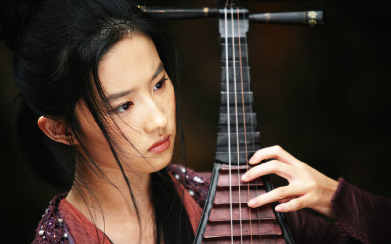 woman playing traditional instrument