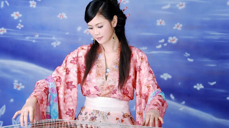 woman playing traditional instrument