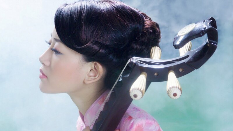 woman playing traditional instrument