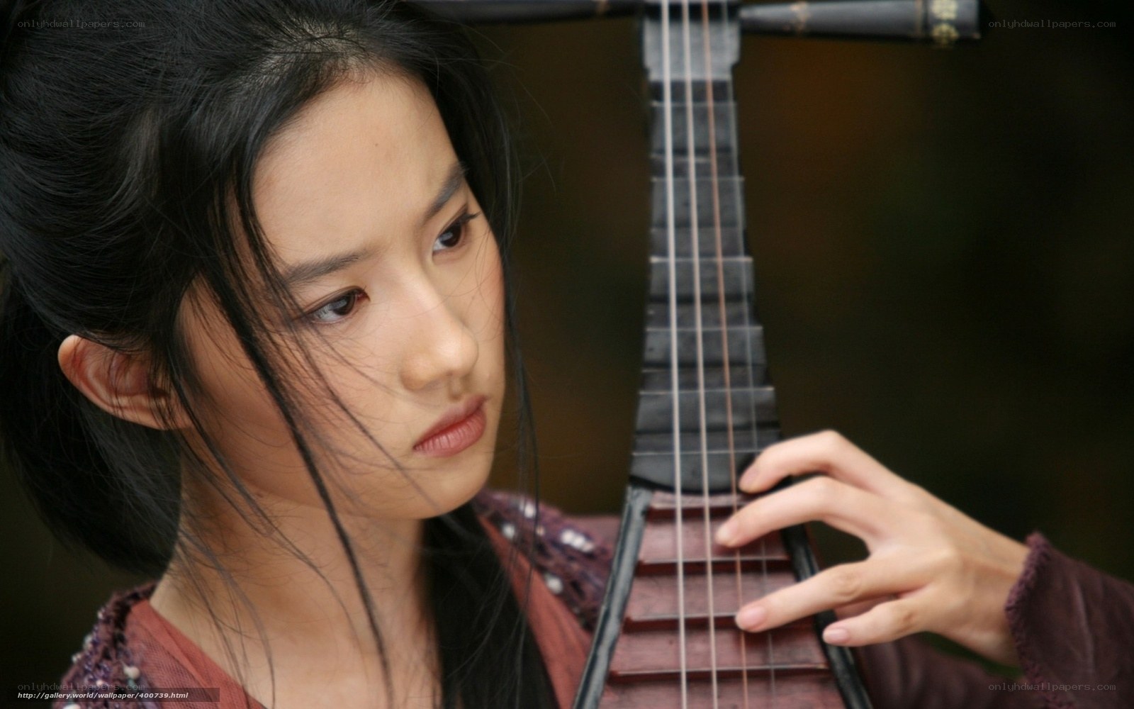 woman playing traditional instrument