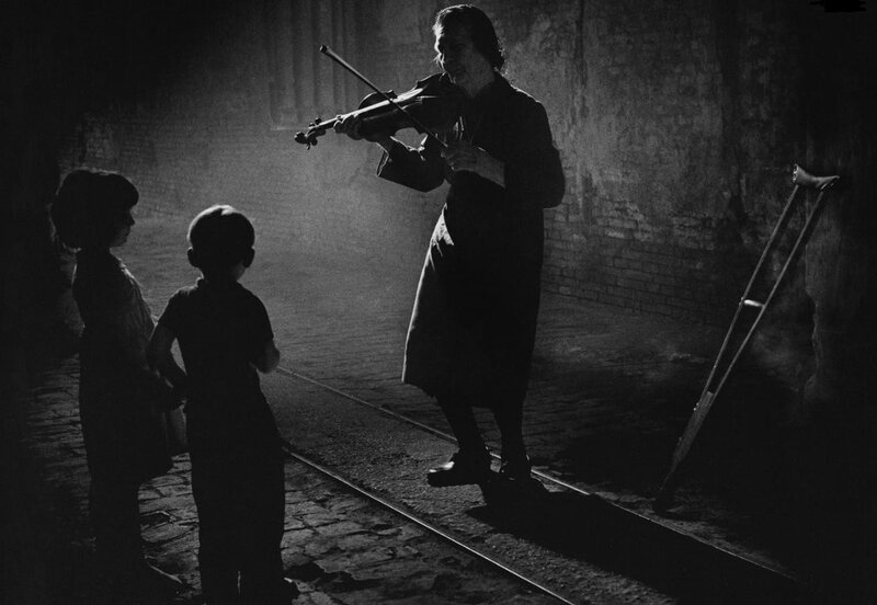 Woman playing violin for children