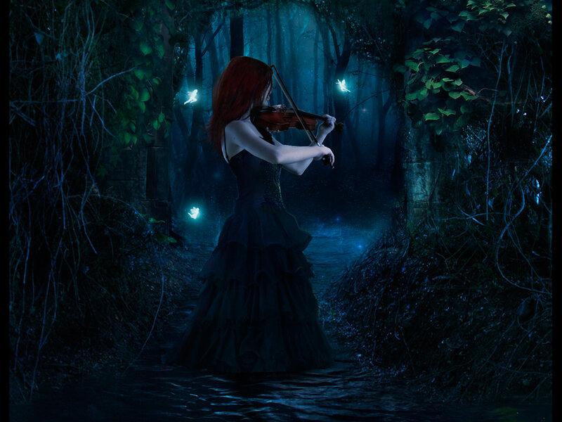 Woman playing violin in a forest