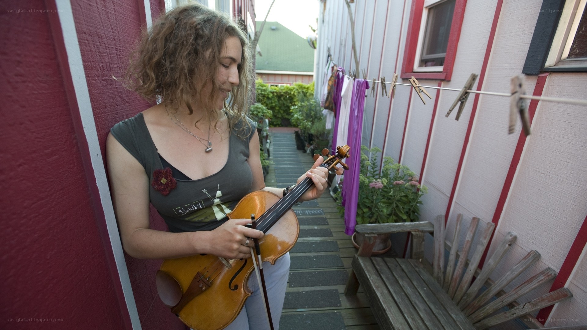 Woman playing violin in alley
