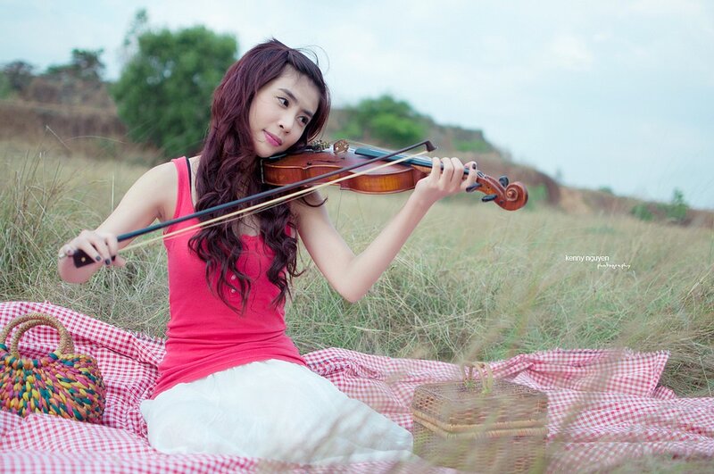 Woman playing violin in field