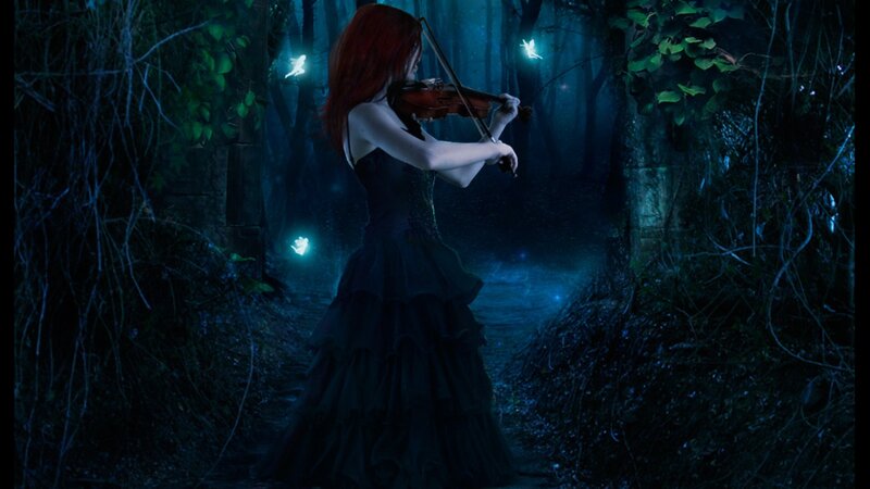 woman playing violin in forest