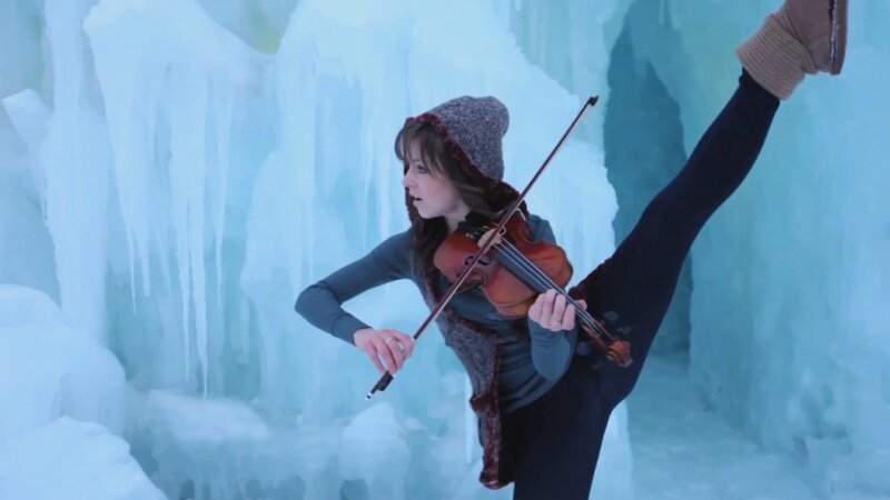 woman playing violin in ice cave