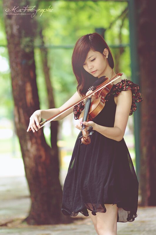 woman playing violin in park