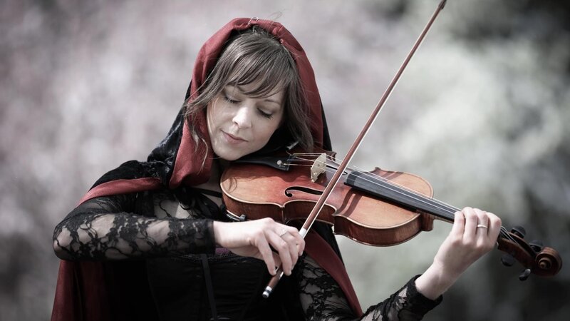 woman playing violin in red cloak