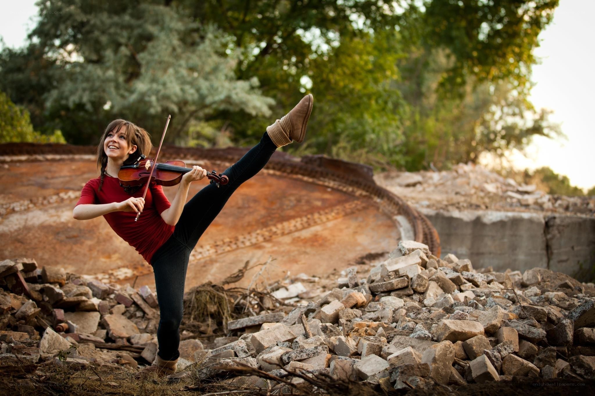 woman playing violin in rubble